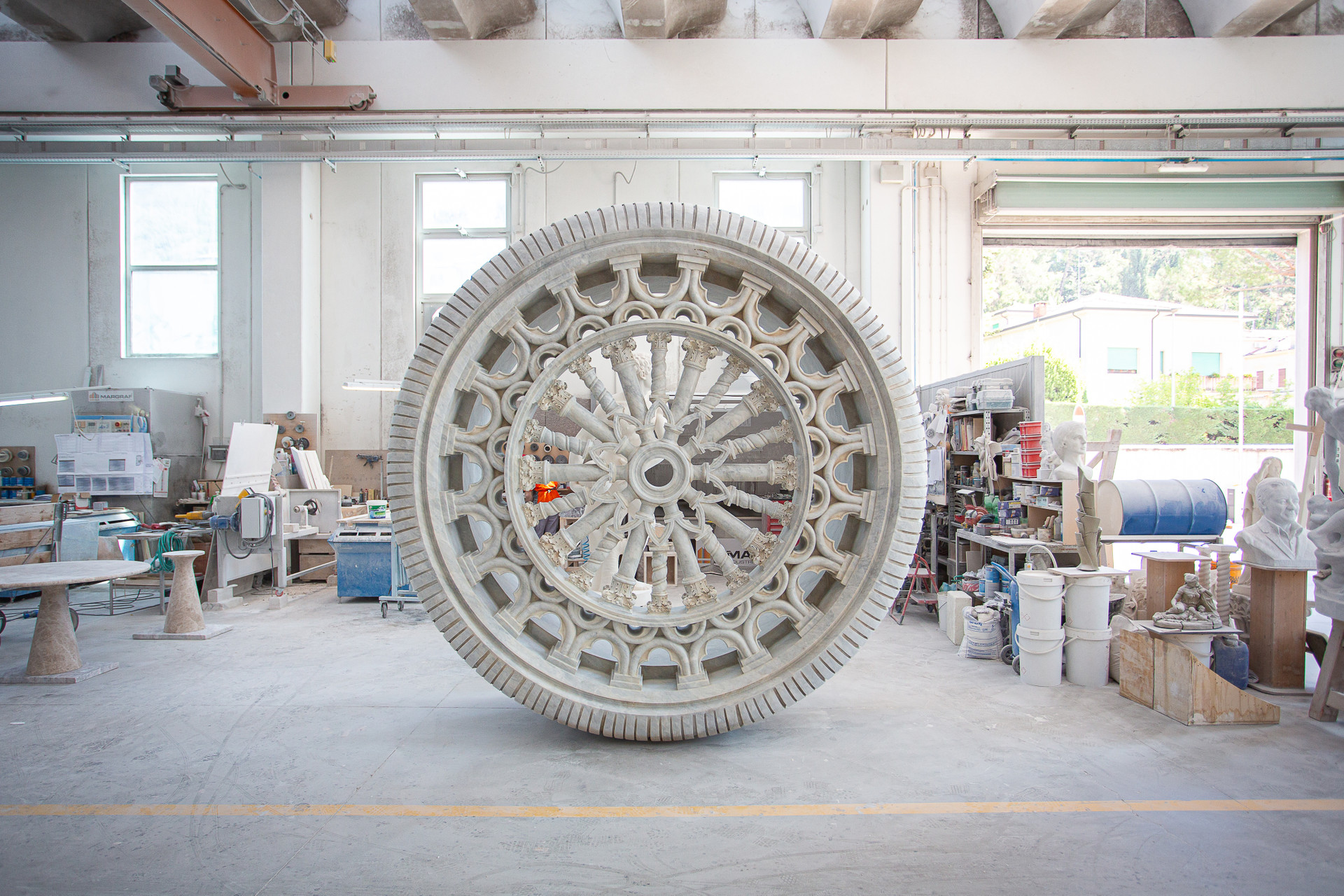 Intricate circular marble carving wheel in artist workshop showcasing precision craftsmanship